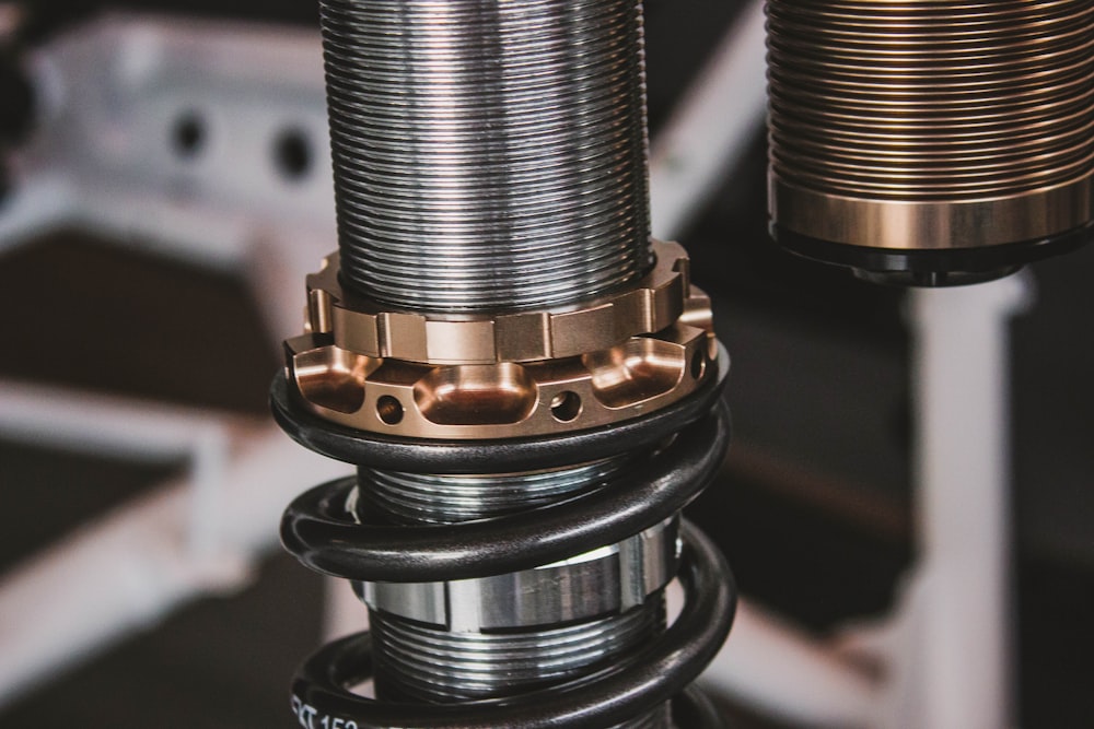 Close-up of an adjustable coilover suspension spring and collar